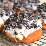 Chocolate Iced and Cream-Filled Chocolate Round Donut With Crushed Oreos