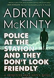 Police at the Station and They Don't Look That Friendly (Adrian McKinty)