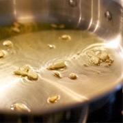 Smelling Garlic and Olive Oil Frying in a Pan