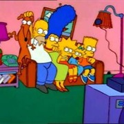 Homer Sits on Santa's Little Helper