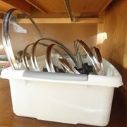Use a Dishpan to Store Pot Lids