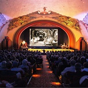 See a Silent Movie in a Theatre With a Piano Player or Orchestra