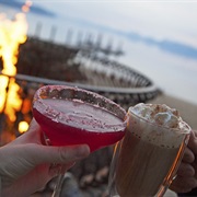 Watch Skiers and Snowboarders Biff It While Drinking Wine Inside