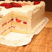 White Sheet Cake With Whipped Cream and Strawberries