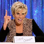 Katya as Suze Orman