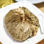 Rice Ball Sprinkled With Sesame Seeds, Wrapped in a Lotus Leaf