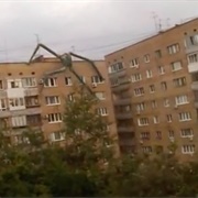 Alien Spider Creature Crawling on Building