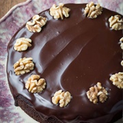 Chocolate Cake With Thick Chocolate Frosting and Whole Walnuts