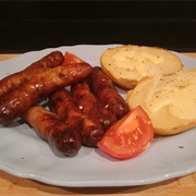 Pork and Honey Chipolatas, Baked Potato and Cheddar Cheese With Grilled Tomato