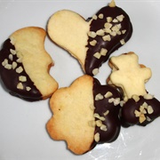 Vegan Chocolate-Dipped Sugar Cookies Filled With Cranberry Butter Cream