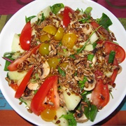 Tomato Melon and Grape Salad With Arugula and Sunflower Seeds