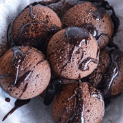 Glazed Chocolate-Filled Pumpkin Round Donut With Chocolate Drizzle, and Chocolate Chips