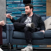 35. David Krumholtz Wears a Blue Zip-Up Jacket and Grey Sneakers