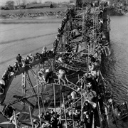 Flight of Refugees Across Wrecked Bridge in Korea (1950)
