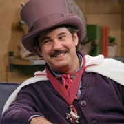 20. Lord Andrew Lloyd Webber Wears a Purple Top Hat & Fabrice Fabrice Wears One Pink Fur Leg Warmer