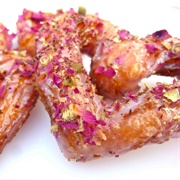 Rose Iced and Strawberry-Filled Cruller With Plum Drizzle