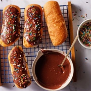 Chocolate Iced and Cookie Dough-Filled Pumpkin Long John With Crushed Peanuts