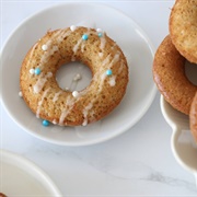 Powdered Sugar Chocolate-Filled Pumpkin Ring Donut With Orange Drizzle