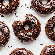 Chocolate Iced and Chocolate-Filled Chocolate Ring Donut With Chocolate Drizzle, and Chocolate Chips