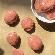 Strawberry Iced and Strawberry-Filled Red Velvet Round Donut With Chocolate Drizzle