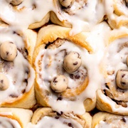 Cookie Dough-Filled Cinnamon Sugar Roll Donut With Crushed Peanuts