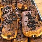 Powdered Sugar Cream-Filled Chocolate Long John With Chocolate Chips