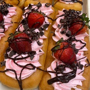 Strawberry Iced and Strawberry-Filled Long John With Chocolate Chips