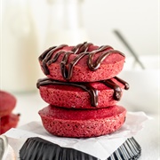 Strawberry Iced and Strawberry-Filled Red Velvet Long John With Plum Drizzle