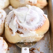 Cream-Filled Cinnamon Sugar Roll Donut With Vanilla Drizzle