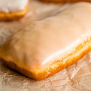Rose Iced and Cookie Dough-Filled Pumpkin Long John With Orange Drizzle