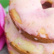 Rose Iced and Strawberry-Filled Chocolate Cruller With Crushed Peanuts