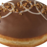 Chocolate Iced and Chocolate-Filled Chocolate Round Donut With Chocolate Drizzle and Chocolate Chips