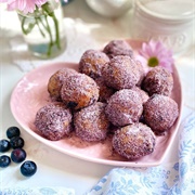 Blue Iced Blueberry Round Donut With Orange Drizzle and Coconut