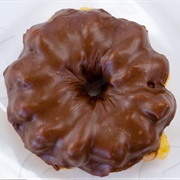 Chocolate Iced and Blueberry Custard-Filled Blueberry Cruller With Chocolate Drizzle