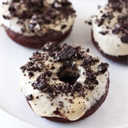 Powdered Sugar Chocolate-Filled Pumpkin Ring Donut With Crushed Oreos