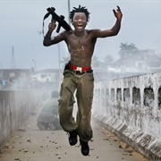 A Government Militia Commander Exults After Firing a Rocket-Propelled Grenade... (Chris Hondros)