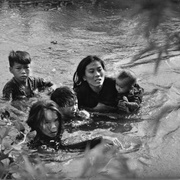 A Mother and Her Children Wade Across a River to Escape US Bombing (Kyoichi Sawada)