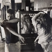 Brooklyn Gang. Coney Island. Kathy Fixing Her Hair in a Cigarette Machine Mirror (Bruce Davidson)