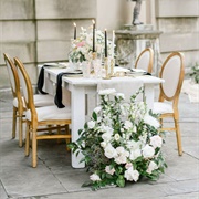 Flowers on Floor Next to Tables
