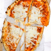 Orange Naan Pizza With Scrambled Eggs and Parmesan