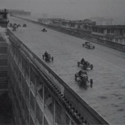 Cars Racing Around the Oval Track on the Rooftop of the Fiat Workers in Turin