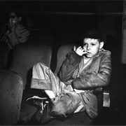 Boy With Finger in His Mouth in a Movie Theater, New York (Weegee)