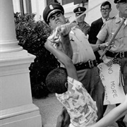 Policeman Rips Flag From Young Boy (Matt Herron)