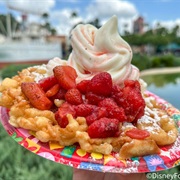 Funnel Cake With Strawberry Topping and Vanilla Ice Cream